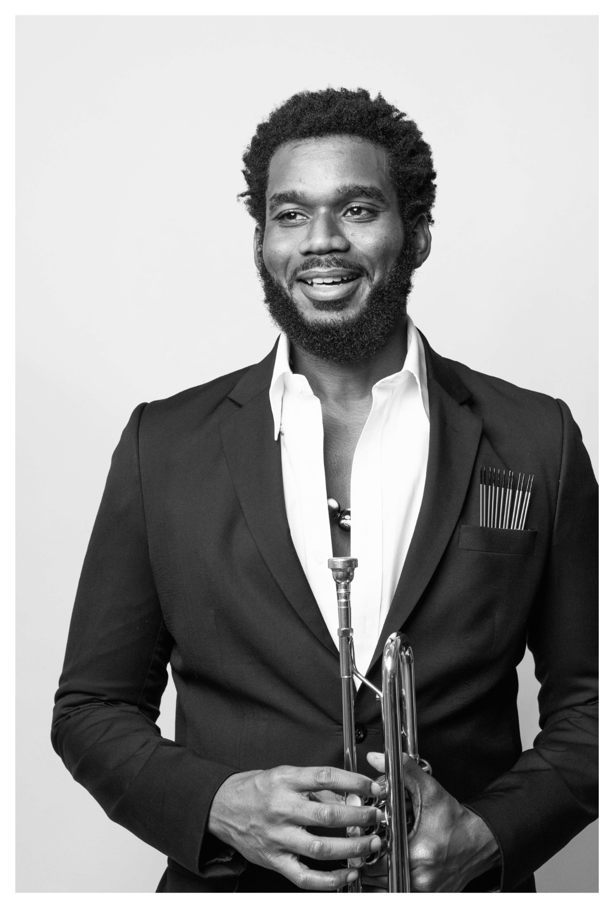 Jelani Akil Bauman holding a trumpet